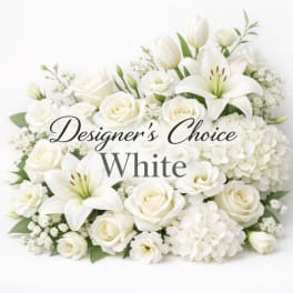 White roses, lilies, and hydrangeas arranged in a low bouquet