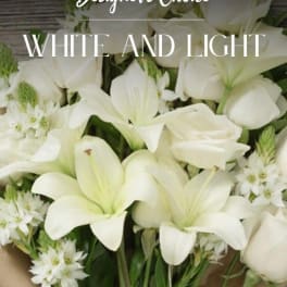 White lilies and small white flowers in a bouquet