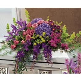 Colorful casket spray with purple, pink, and yellow flowers