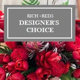 Red floral arrangement with a designer's choice sign