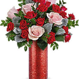 Red and pale pink roses in a red vase