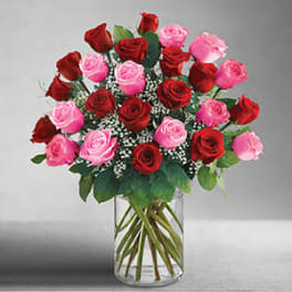 Bouquet of red and pink roses in a clear glass vase