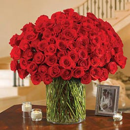 Large bouquet of red roses in a clear glass vase