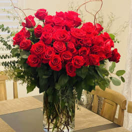 Large bouquet of red roses in a clear glass vase