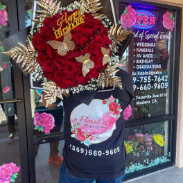 Large red rose bouquet with gold butterfly accents and a Happy Birthday sign