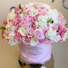 Pink and white rose bouquet in a pale pink hat box
