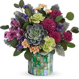 Mixed bouquet with succulents and purple flowers in a mosaic vase