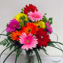 Colorful gerbera daisy bouquet in a clear glass vase