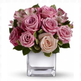 Pink rose bouquet in a clear square vase