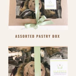 Box of assorted pastries tied with a pale green ribbon