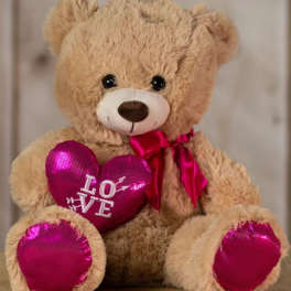 Plush teddy bear holding a pink heart with "LOVE" text