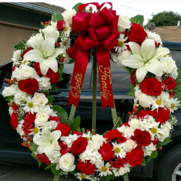Large red, white, and cream floral wreath with a red bow