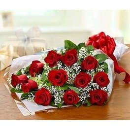 Bouquet of red roses with baby's breath wrapped in white paper