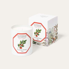 White candle in a tomato-labeled glass jar with matching box