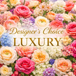 Assorted luxury roses and mixed flowers in bright and pastel colors with Designer’s Choice Luxury text in the center