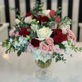 Mixed roses and tulips in a clear glass vase