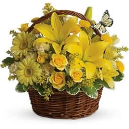 Yellow floral basket arrangement with a butterfly accent