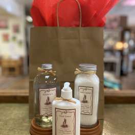 Gift bag with bath products and red tissue paper