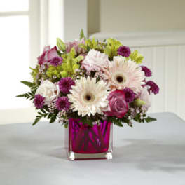 Pink and white mixed bouquet in a magenta glass vase