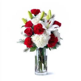 Red and white floral arrangement in a clear glass vase