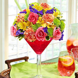Colorful bouquet in a red martini glass vase