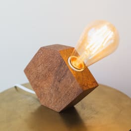 Wooden geometric lamp with a glowing Edison bulb