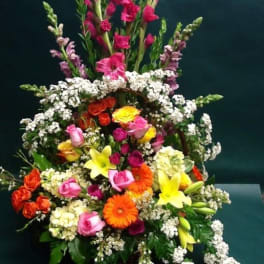 Tiered bouquet with pink, yellow, orange, and white flowers