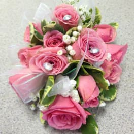 Pink rose bouquet with white filler flowers and ribbon accents