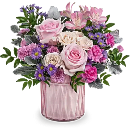 Pink and purple mixed flower arrangement in a pink vase