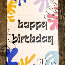 Birthday greeting card with black text and colorful abstract shapes on a white background