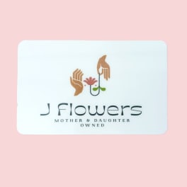 White business card with a flower logo on a pink background