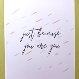 White greeting card with 'just because you are you' text and scattered pastel dashes.