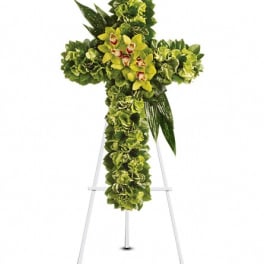 Green floral cross on a white easel stand