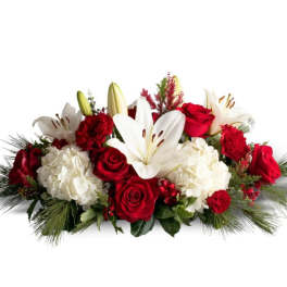 Red roses and white lilies arranged with white hydrangeas