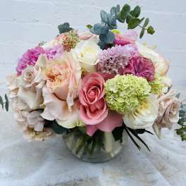 Mixed pink and white roses in a glass vase