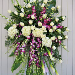 Large standing sympathy spray with white roses, orchids, and calla lilies
