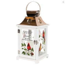 White memorial lantern with cardinal and floral artwork and a metal handle