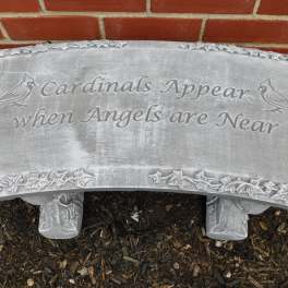 Gray memorial bench with the words Cardinals Appear when Angels are Near