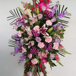 Large standing floral spray with pink, purple, and white blooms on an easel
