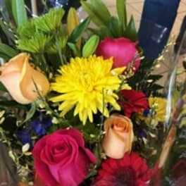 Mixed bouquet with roses and bright yellow flowers