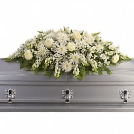 White chrysanthemum casket spray arranged on a closed silver casket