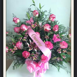 Pink rose bouquet with lilies and a pink ribbon