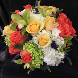 Bouquet of coral and yellow roses with white hydrangeas and purple accents