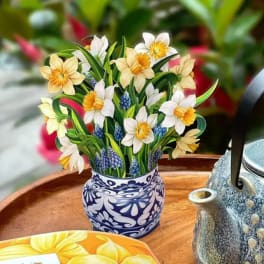 Pop-up bouquet of daffodils in a patterned vase