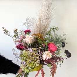 Loose bouquet with roses, hydrangea, and dried grasses