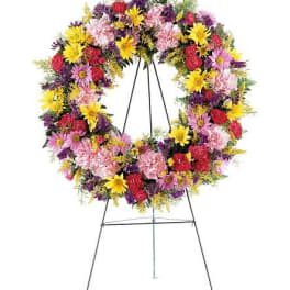 Colorful standing floral wreath on a metal easel