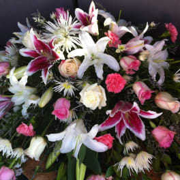Large floral spray with white lilies, pink roses, and carnations