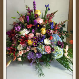 Large mixed flower basket with roses, hydrangeas, lilies, and irises