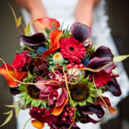 Bride holding a colorful bouquet with calla lilies and gerbera daisies