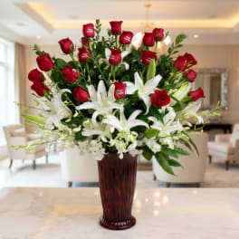 Red roses and white lilies arranged in a tall vase